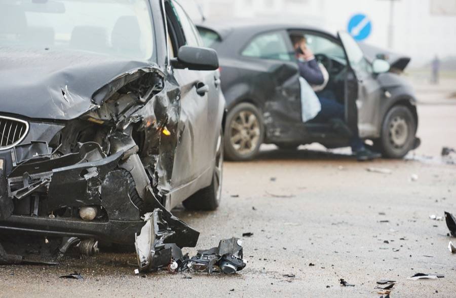 Black car damaged in a vehicle collision in London, ON