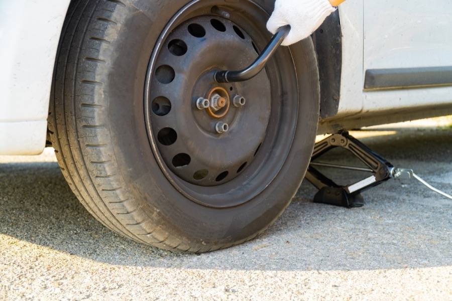 Changing a flat tire on the side of the road