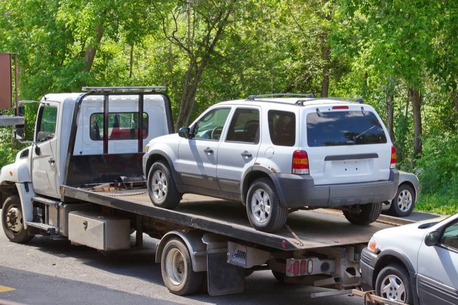 SUV being towed on a flatbed tow truck